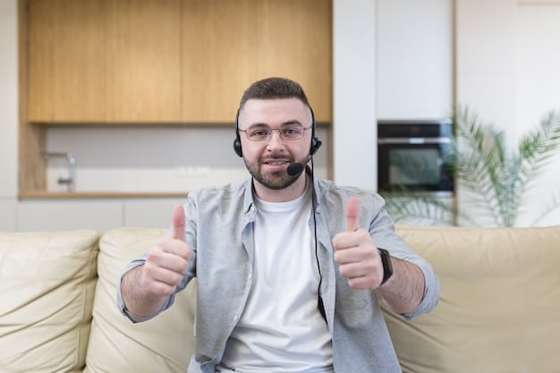 A happy customer is giving a thumbs up while talking to a customer support agent on a video call.
