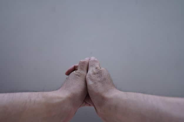 A close-up shot of two hands clasped together in a gesture of support and understanding. The background is blurred, suggesting a professional setting, possibly an office. The lighting is soft and warm, emphasizing the feeling of comfort and reassurance.