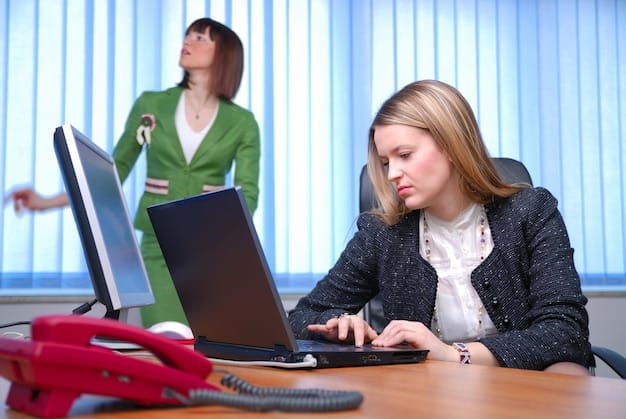 A customer service representative typing a response to a negative review on a computer. The representative looks calm and focused, showcasing the importance of remaining professional and composed when addressing customer complaints.