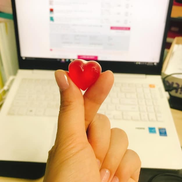 A close-up of a customer's hand clicking a heart icon on an e-commerce site featuring a personalized product recommendation, symbolizing customer loyalty and the positive emotional connection fostered through e-commerce customer retention strategies.